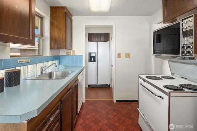 6743 40th Ave SW, Seattle, WA 98136 - kitchen featuring white appliances, dark floors, decorative backsplash, and light countertops