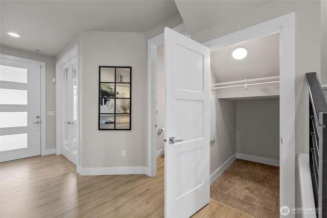 spacious closet featuring light wood-style flooring and visible vents