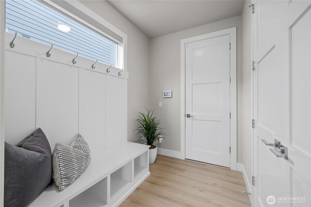 mudroom featuring light wood-style floors and baseboards