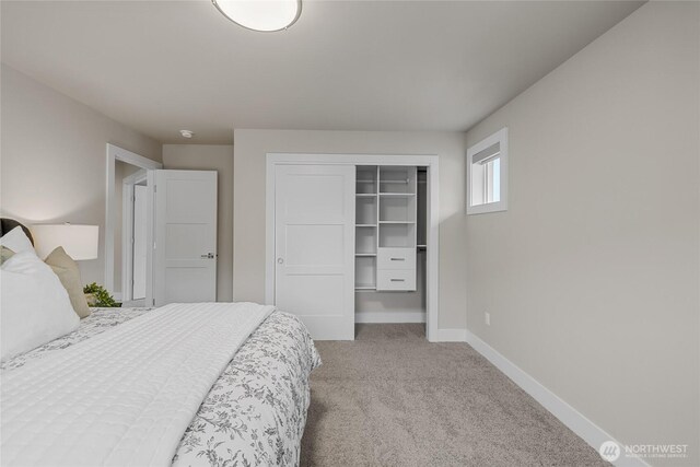 bedroom with baseboards, carpet, and a closet
