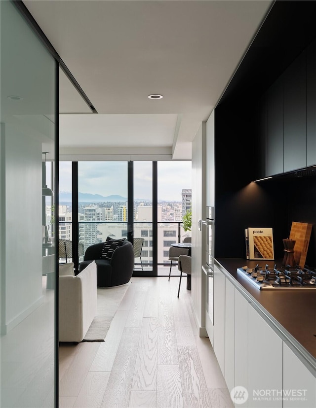 300 Virginia St Unit 2701, Seattle, WA 98101 - interior space with light wood-type flooring, a view of city, and a wall of windows