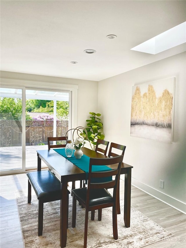 2940 161st Ave SE, Bellevue, WA 98008 - dining area with light wood-style floors, a skylight, baseboards, and recessed lighting