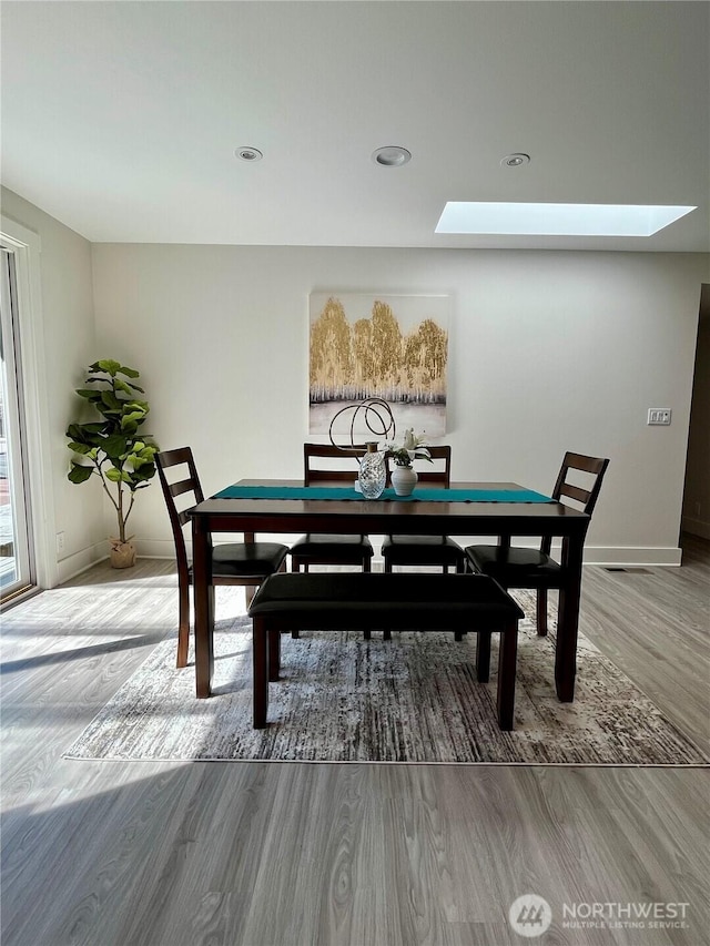 2940 161st Ave SE, Bellevue, WA 98008 - dining room with wood finished floors, a skylight, baseboards, and recessed lighting