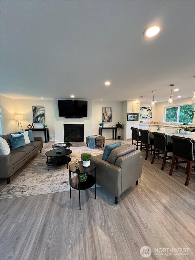 2940 161st Ave SE, Bellevue, WA 98008 - living area featuring light wood-type flooring, a fireplace, and recessed lighting