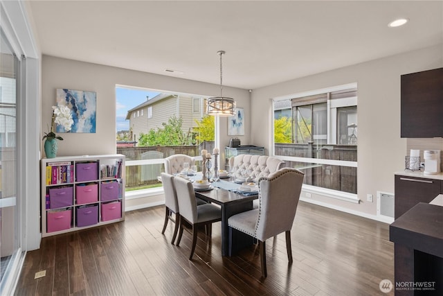 dining room with recessed lighting, baseboards, dark wood-style flooring, and a notable chandelier
