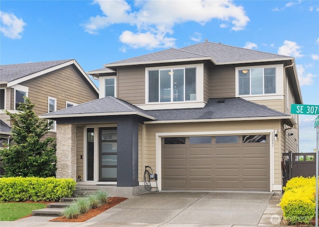 view of front of house with a garage, fence, and driveway