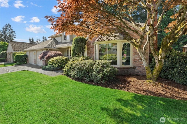 view of property hidden behind natural elements with a garage, driveway, a front yard, and brick siding