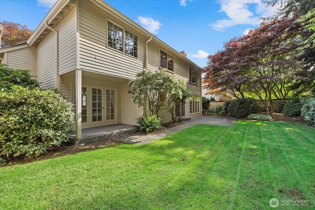 back of property with a patio, a chimney, and french doors