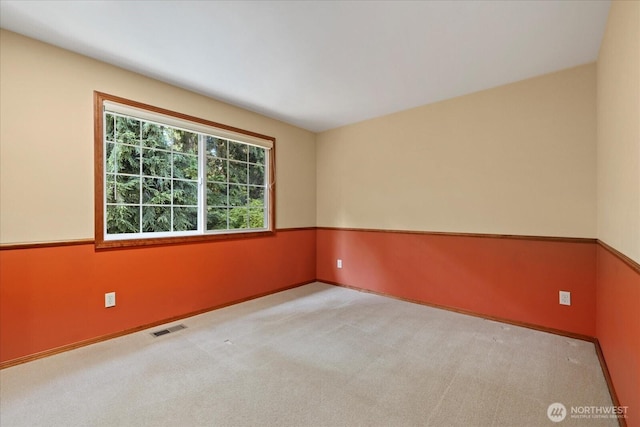 empty room with carpet floors and baseboards
