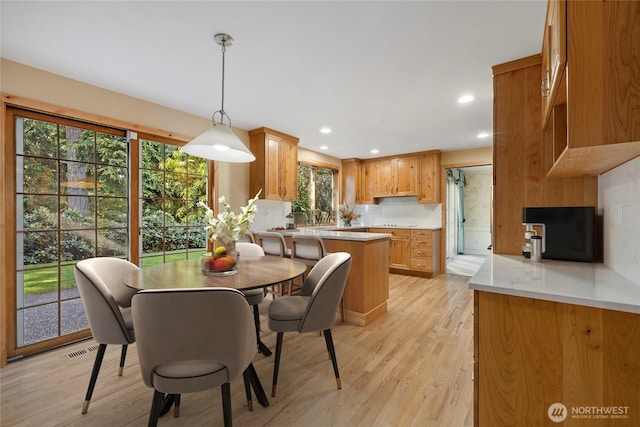 dining room featuring light wood finished floors and recessed lighting