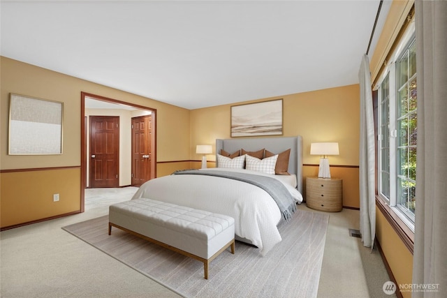 bedroom featuring light carpet
