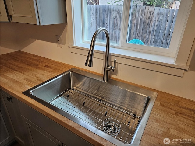 interior details with a sink and wood counters