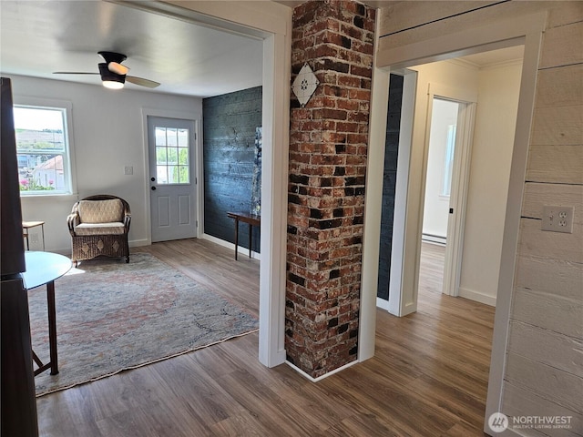 entryway with baseboards, baseboard heating, a ceiling fan, and wood finished floors