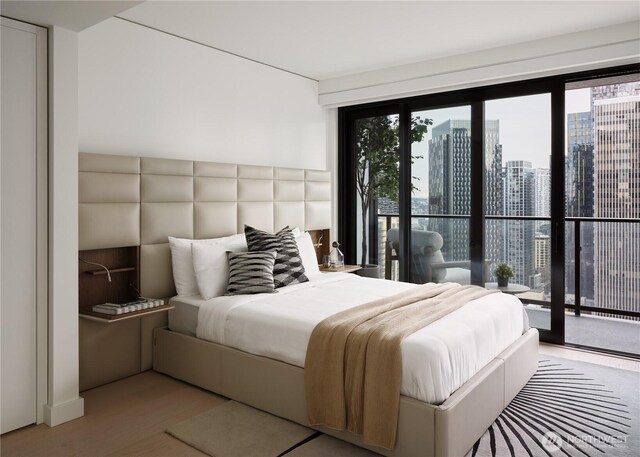bedroom with a view of city, wood finished floors, and access to exterior