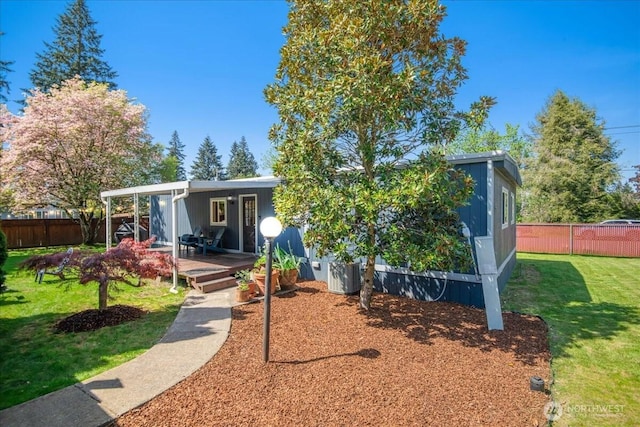 view of front of home with fence, central air condition unit, a deck, and a front lawn