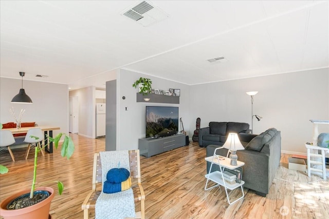 living area featuring visible vents and light wood-style flooring