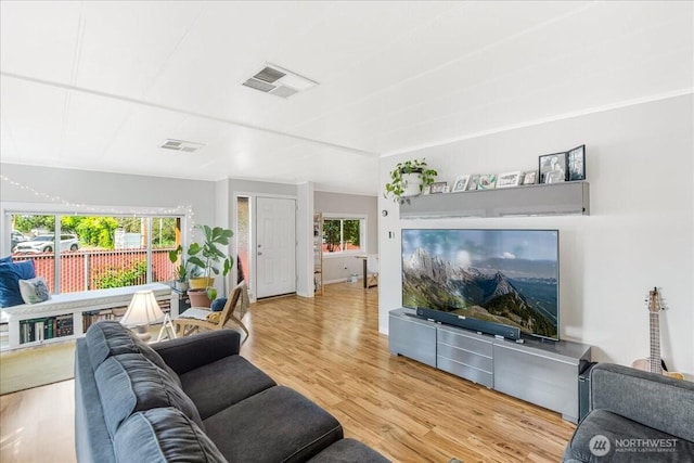 living area featuring wood finished floors and visible vents