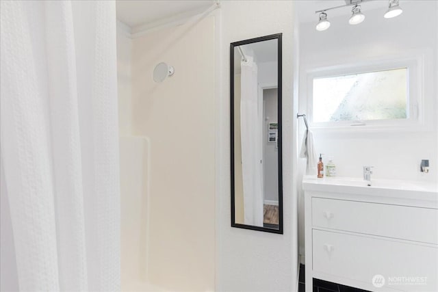 bathroom featuring vanity and a walk in shower