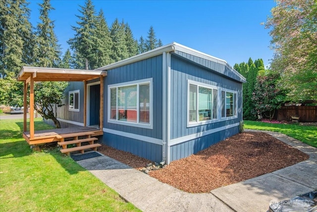 view of home's exterior featuring a lawn and fence