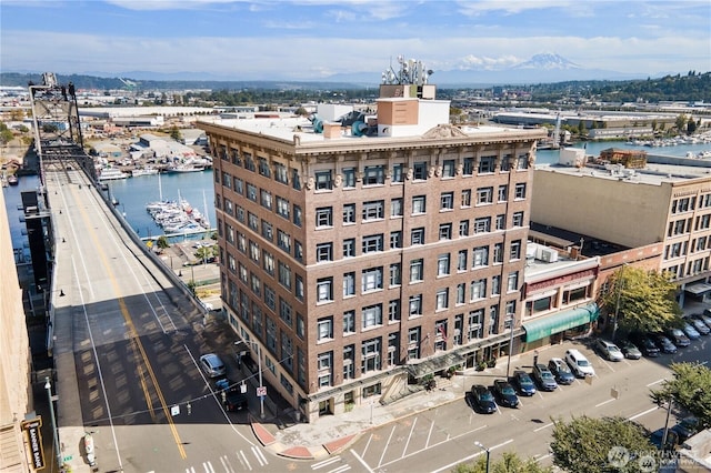 birds eye view of property featuring a water and mountain view and a city view