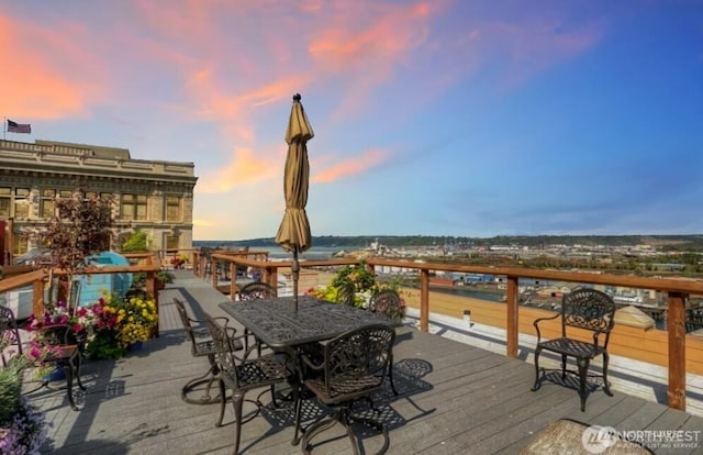 deck at dusk with outdoor dining space