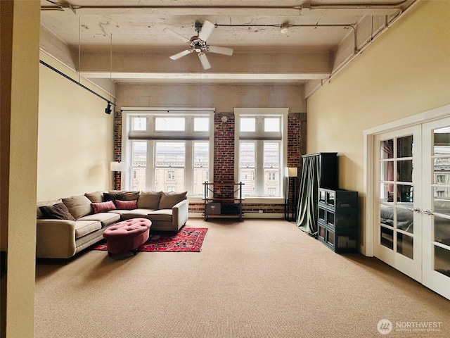 carpeted living room with french doors, a baseboard radiator, ceiling fan, and beamed ceiling