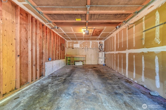 garage with strapped water heater and a garage door opener
