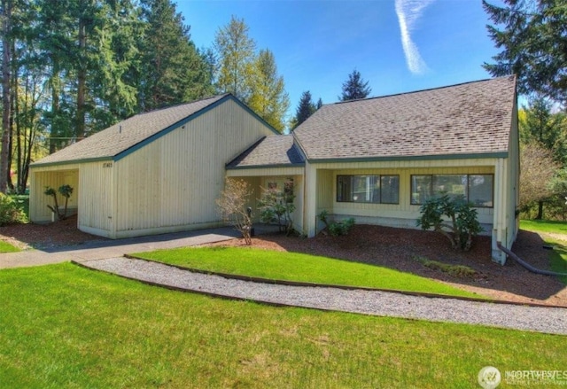 ranch-style house with a shingled roof and a front lawn