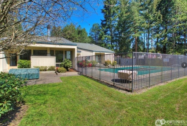 view of pool featuring a yard, fence, and a fenced in pool
