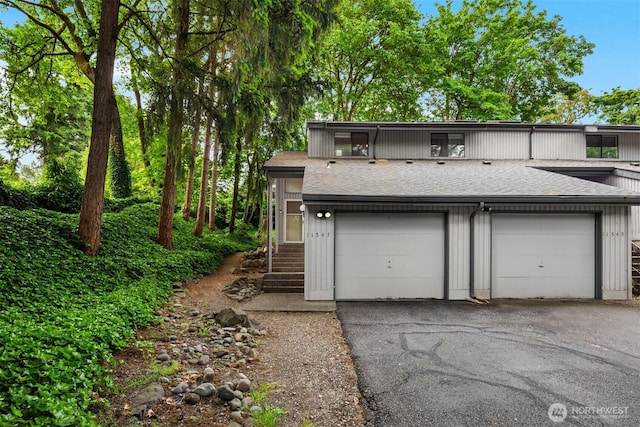 11547 SE 175th St Unit 1, Renton, WA 98058 - view of front of house featuring roof with shingles, a garage, and asphalt driveway