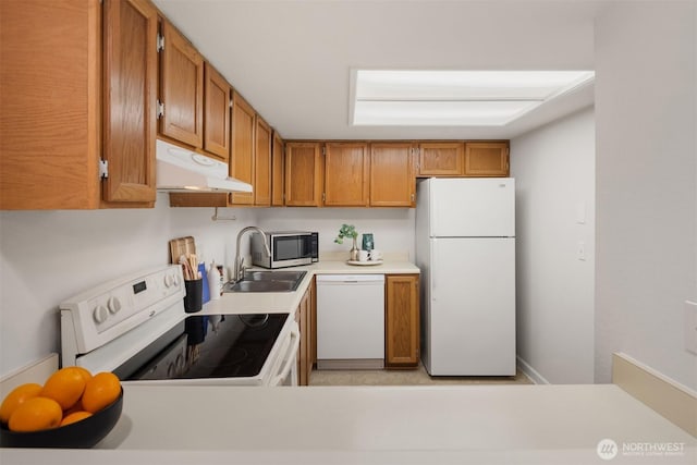 11547 SE 175th St Unit 1, Renton, WA 98058 - kitchen with white appliances, under cabinet range hood, a sink, light countertops, and brown cabinets