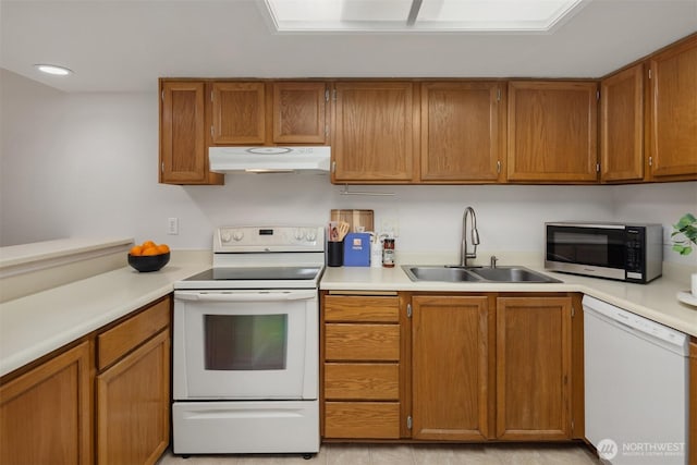 11547 SE 175th St Unit 1, Renton, WA 98058 - kitchen with white appliances, under cabinet range hood, a sink, light countertops, and brown cabinets