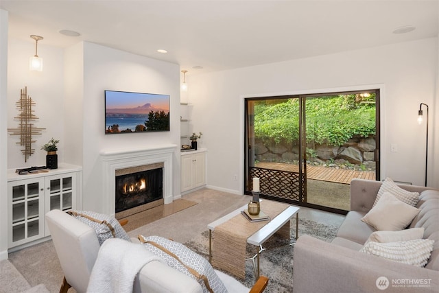 11547 SE 175th St Unit 1, Renton, WA 98058 - living room featuring light carpet, a fireplace with flush hearth, recessed lighting, and baseboards