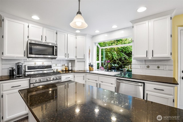kitchen with recessed lighting, a sink, white cabinets, and stainless steel appliances