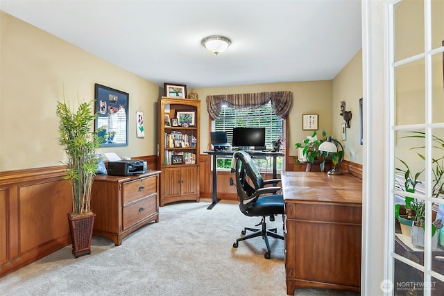 carpeted office with plenty of natural light and a wainscoted wall