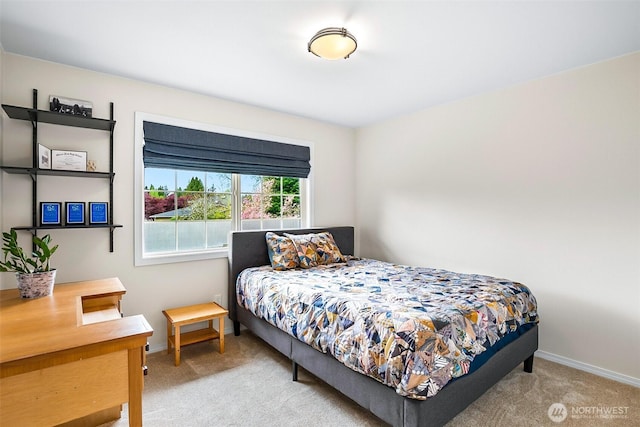 carpeted bedroom featuring baseboards