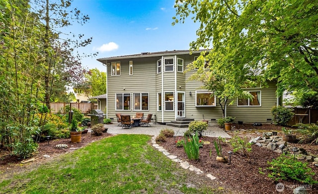 back of property with a lawn, a fenced backyard, a patio area, and crawl space
