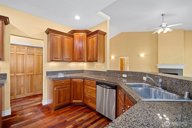 kitchen with a sink, ceiling fan, stainless steel dishwasher, and dark wood finished floors