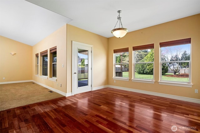 interior space featuring baseboards and wood finished floors