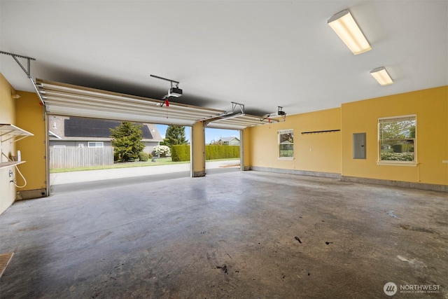 garage featuring a garage door opener and electric panel