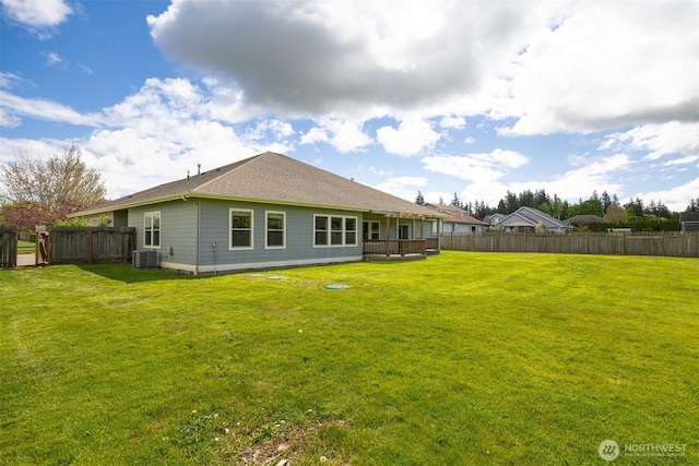 back of property featuring a fenced backyard and a lawn