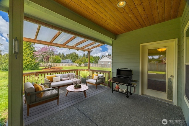 wooden terrace with a lawn, an outdoor living space, and a fenced backyard
