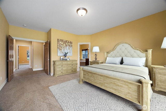 carpeted bedroom featuring baseboards