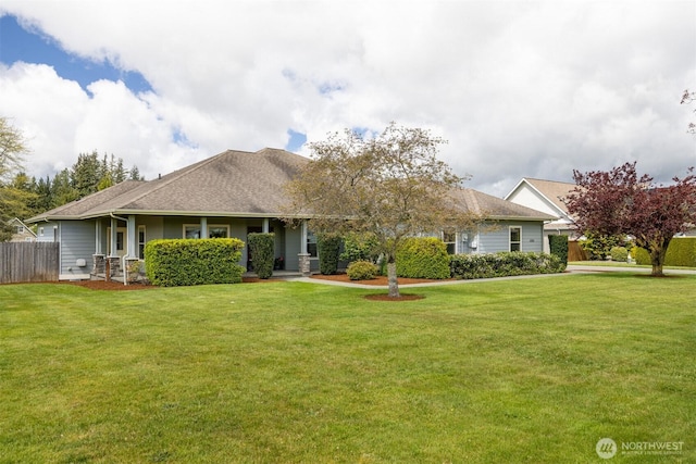 ranch-style house with fence and a front lawn