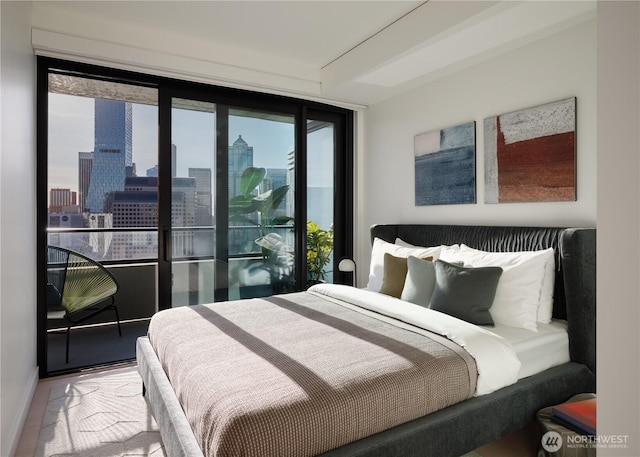 bedroom featuring baseboards and a city view