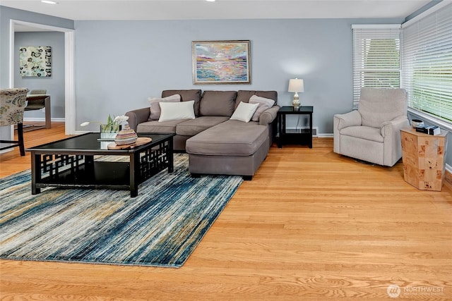living area with baseboards, recessed lighting, and wood finished floors