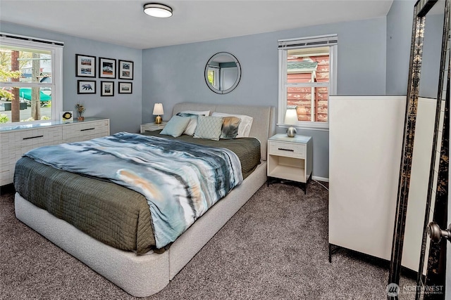 carpeted bedroom featuring baseboards