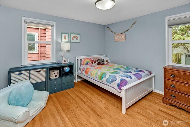 bedroom featuring baseboards and wood finished floors