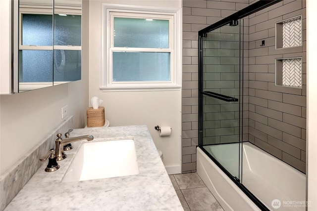 bathroom featuring tile patterned floors, bath / shower combo with glass door, and vanity