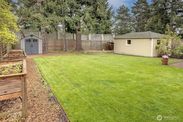 view of yard featuring a fenced backyard, an outdoor structure, a garden, and a storage shed